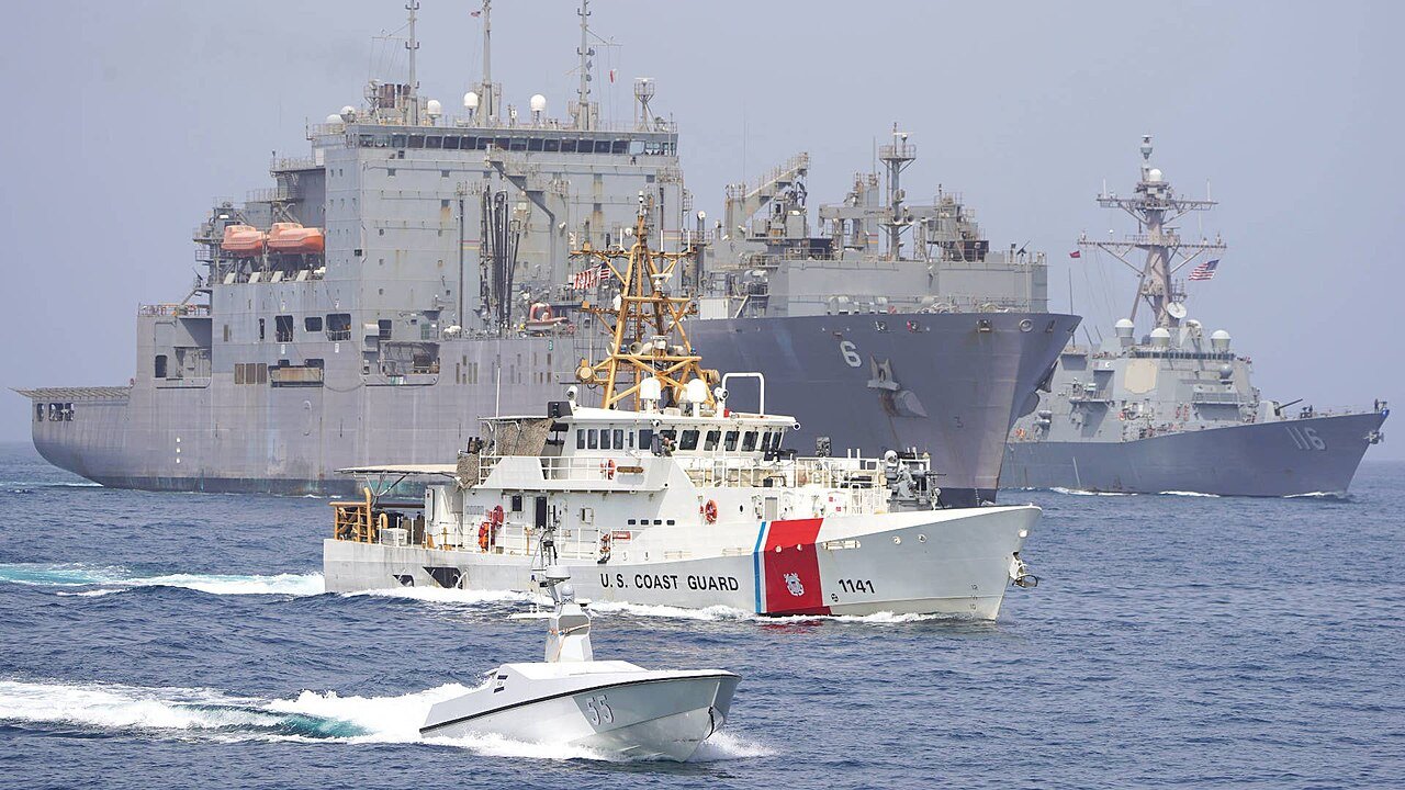 U.S. Navy and Coast Guard vessels escort ships through the Strait of Hormuz amid rising Iran war tensions and maritime security operations