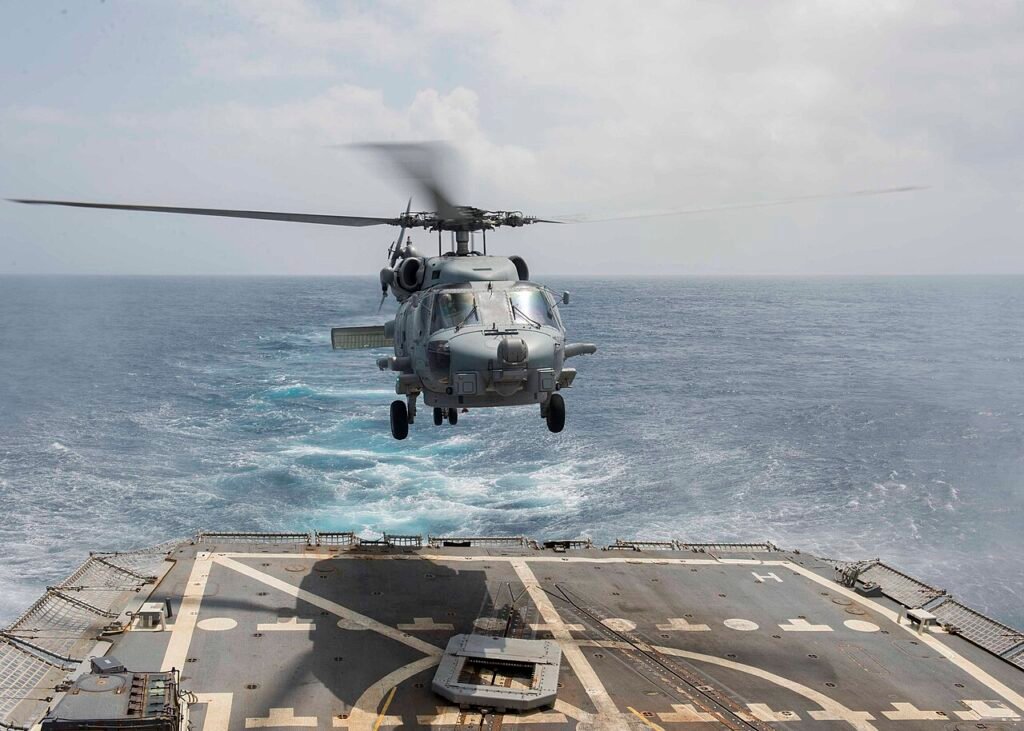 "MH-60R Sea Howk helicopter landing on US Navy destroyer USS Bulkeley at sea"