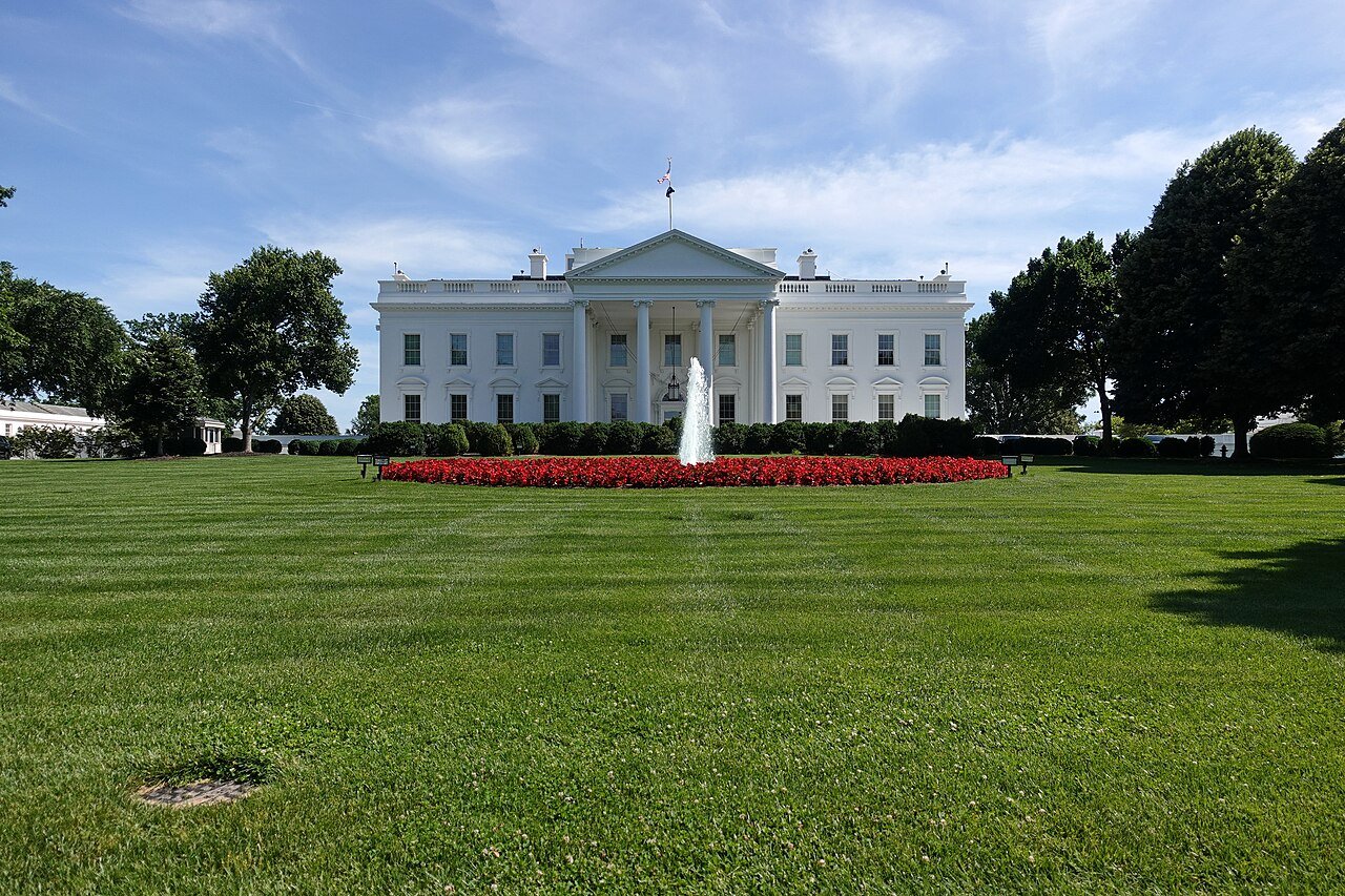 White House exterior with security barriers at sunset